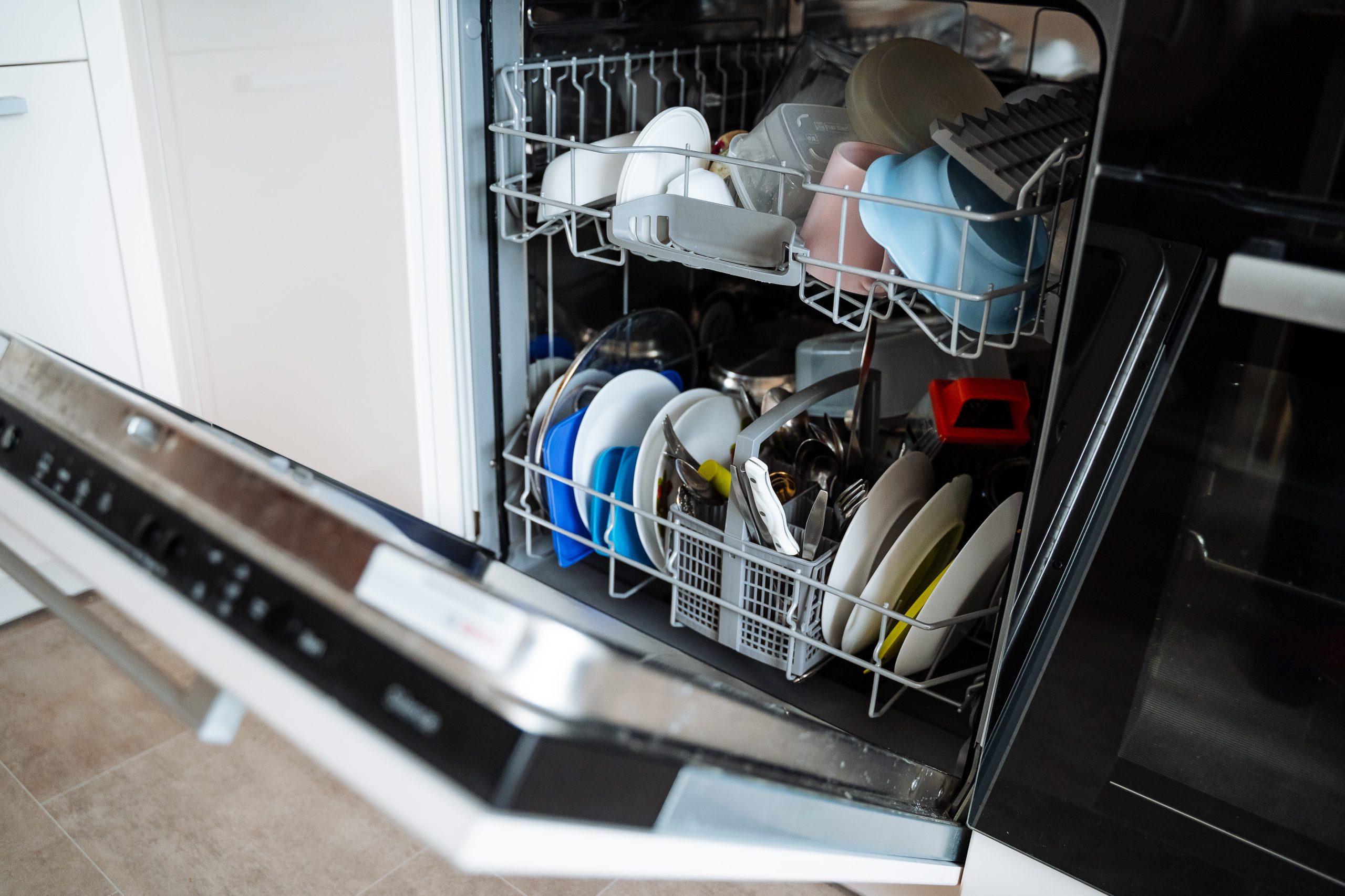 Fully loaded home dishwasher in a modern family kitchen